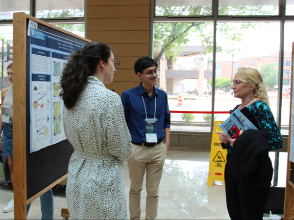 Students present poster to Jo Handelsman