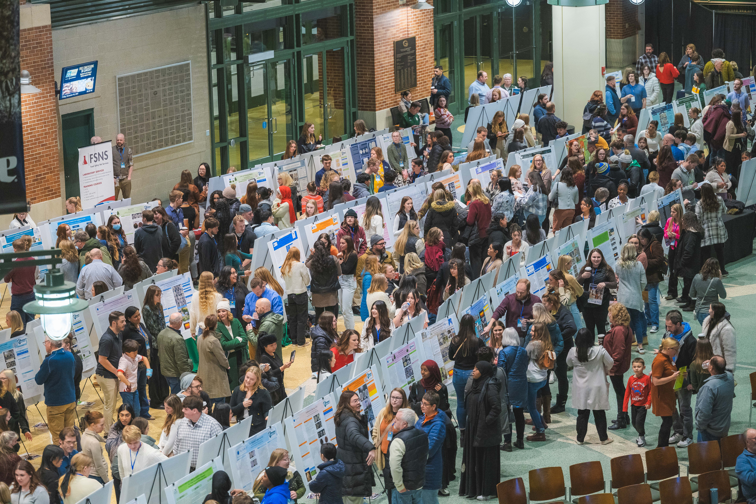 Student posters and presenters in Lambeau Atrium