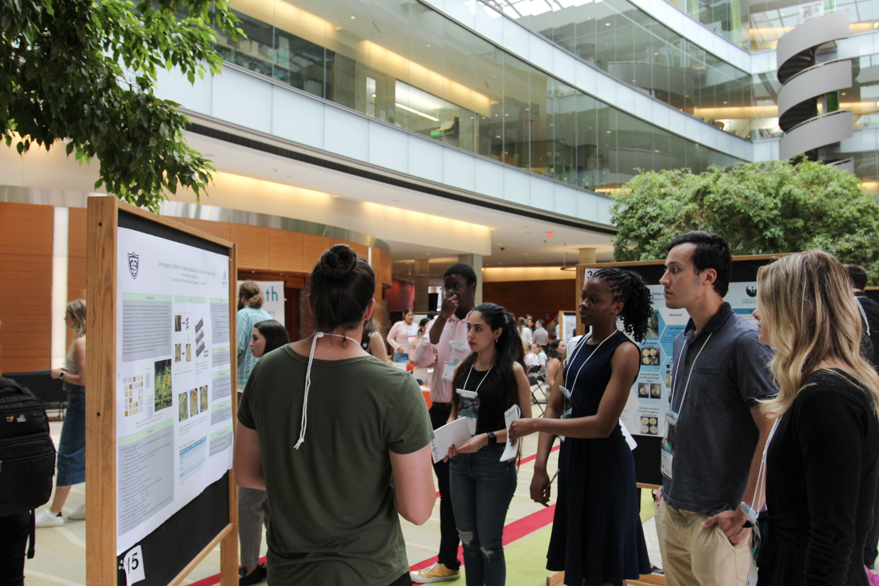 A student presents their research poster